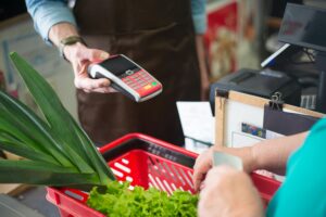 a person using a pos system in grocery store